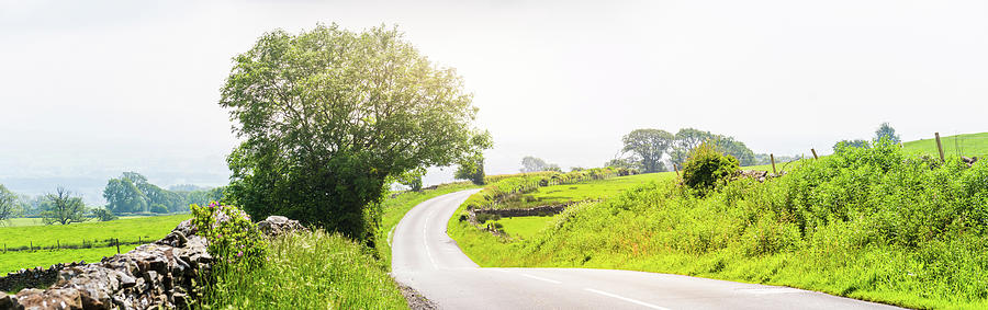 Summer Photograph - Panorama of a curved empty country road with dry stone walls by David Ridley