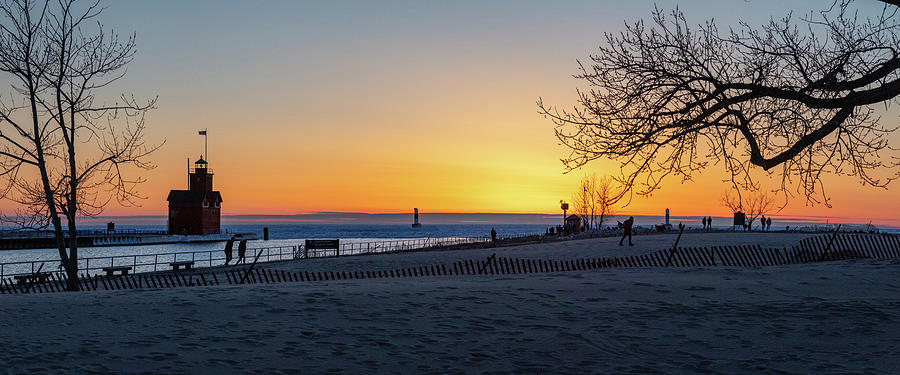 Panoramic view of Holland Michigan Lighthouse at sunset in the winter over Lake Michigan Photograph by Eldon McGraw