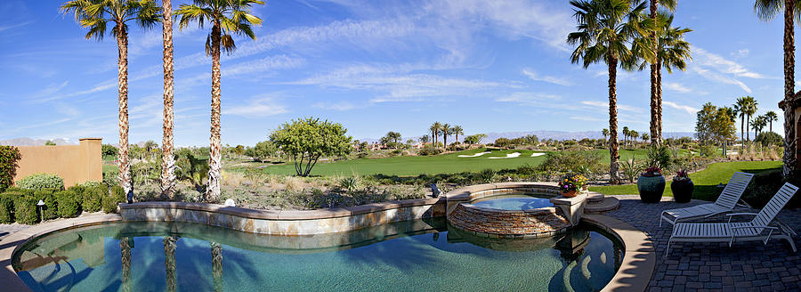 Panoramic view of swimming pool, hot tub and golf course Photograph by Moodboard