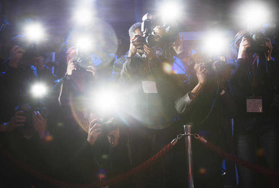 Paparazzi using flash photography at red carpet event Photograph by Caiaimage/Tom Merton