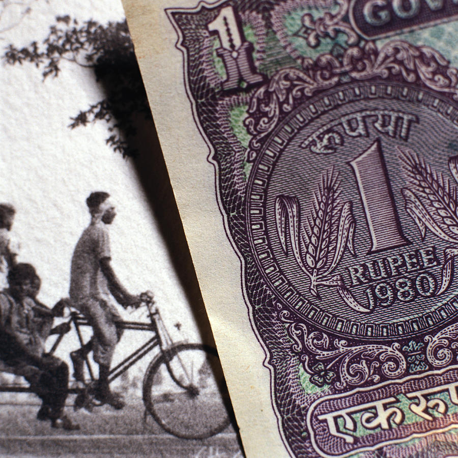 Paper bill next to old photograph. Photograph by Christian Zachariasen