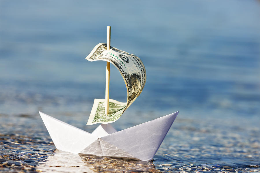 Paper boat with $1 bill sail is blown onshore Photograph by RapidEye