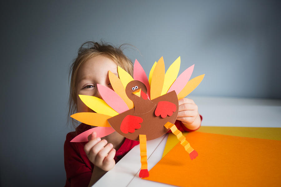 paper craft for kids. DIY Turkey made for thanksgiving day. create art for children. girl playing with a toy Photograph by Natalia Bodrova