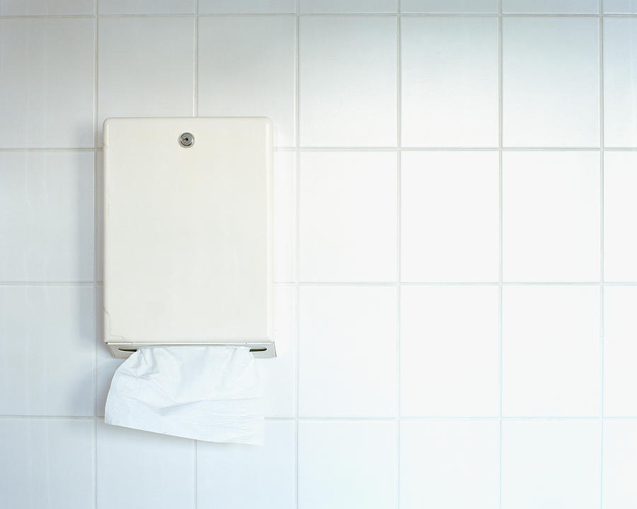 Paper towel dispenser on wall Photograph by Image Source