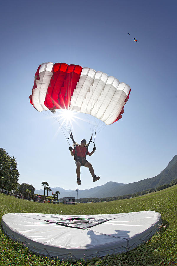 Parachutist performing an accuracy landing Photograph by Oliver Furrer