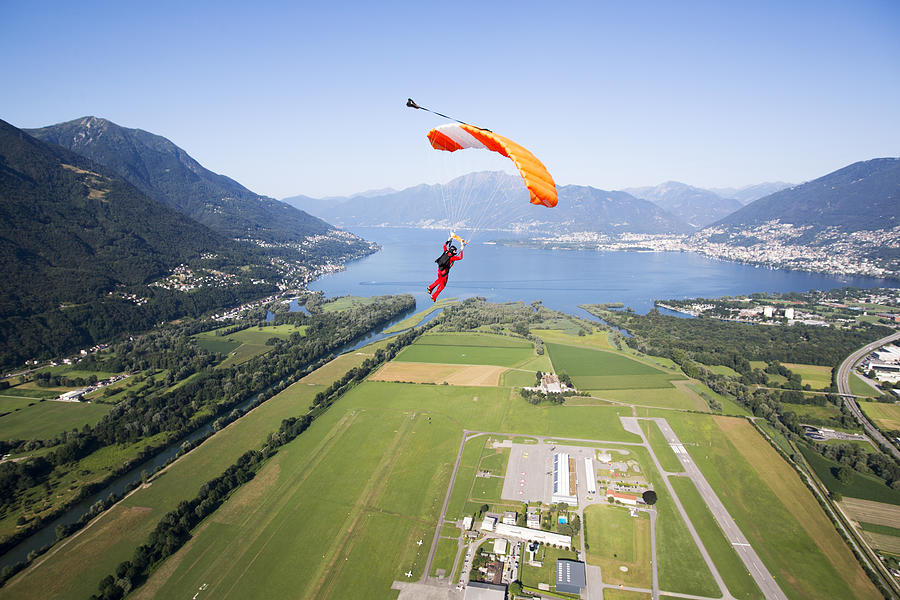 Parachutist under canopy flying high in the sky Photograph by Oliver Furrer