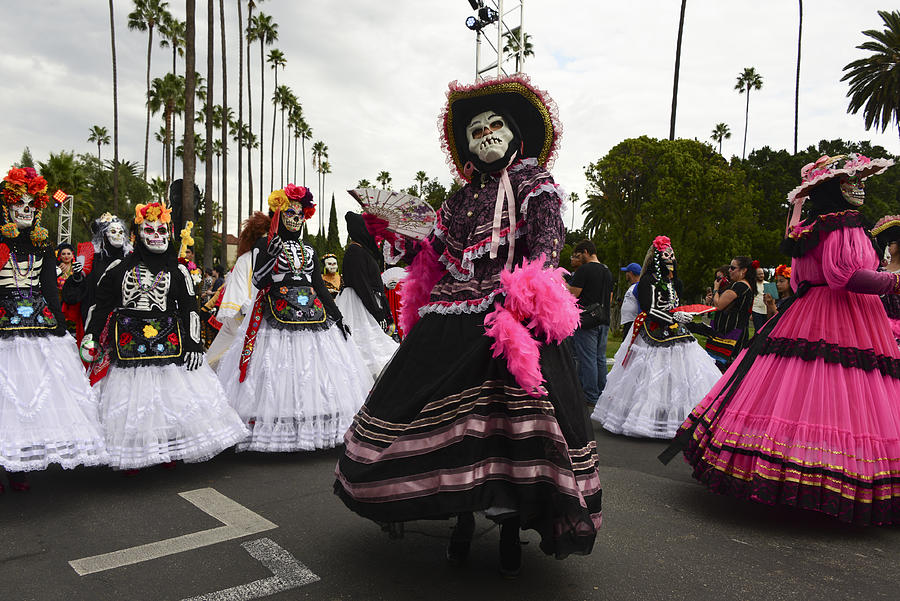 Parade of masked, painted and costumed dancers celebrate Day of the Dead at Hollywood Forever cemetery in Los Angeles, california, USA Photograph by Nik Wheeler
