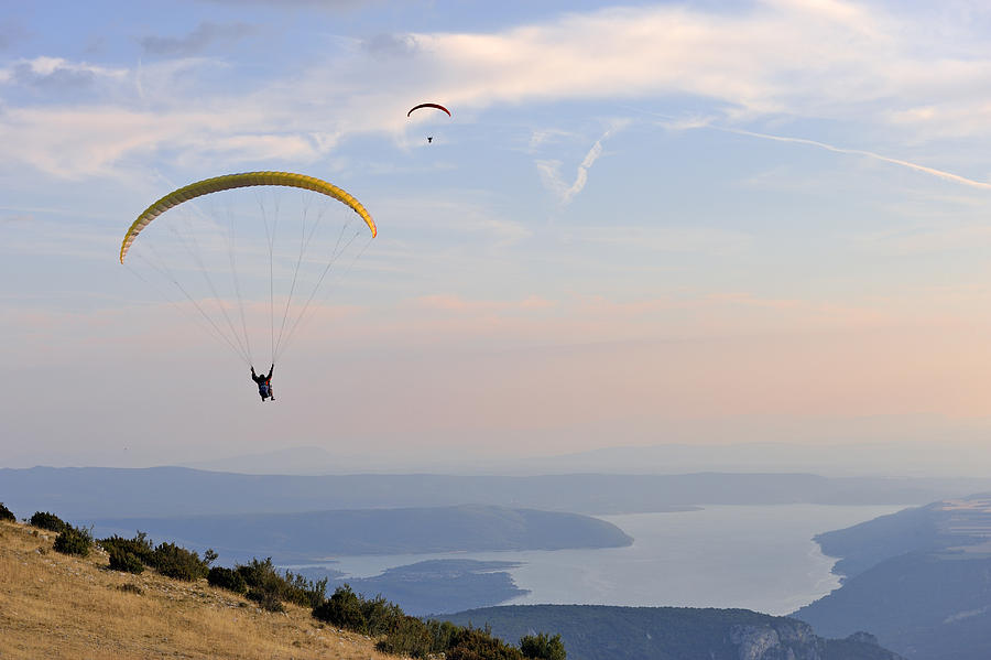 Paragliders flying at sunset, Sainte-Croix lake Photograph by Sami Sarkis