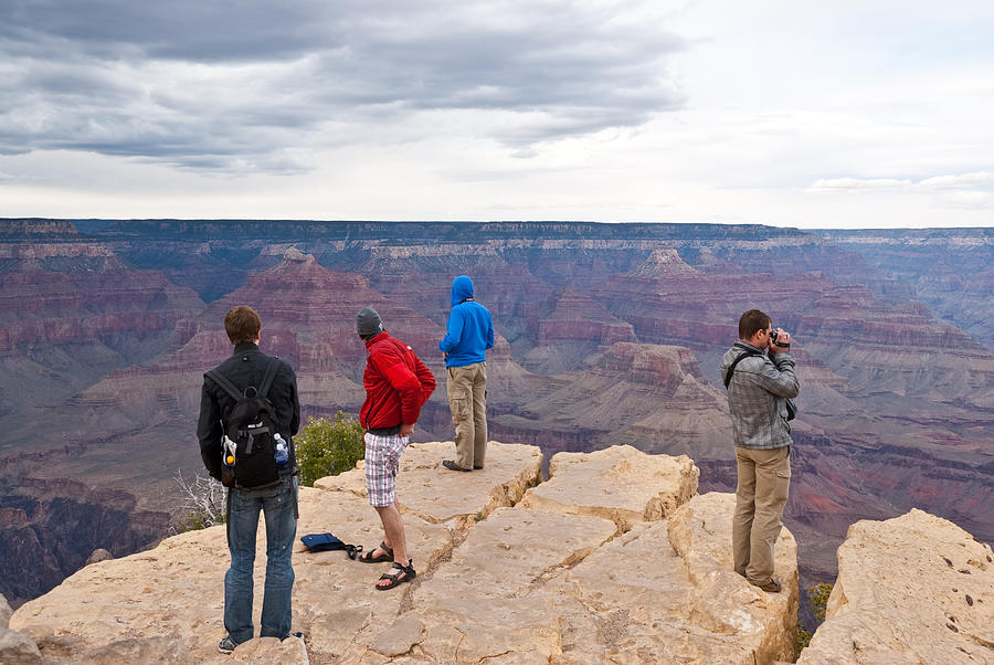 Park Visitors Watch an Approaching Storm from Hopi Point Photograph by JeffGoulden