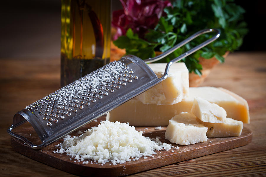 Parmesan cheese with grater Photograph by Alle12