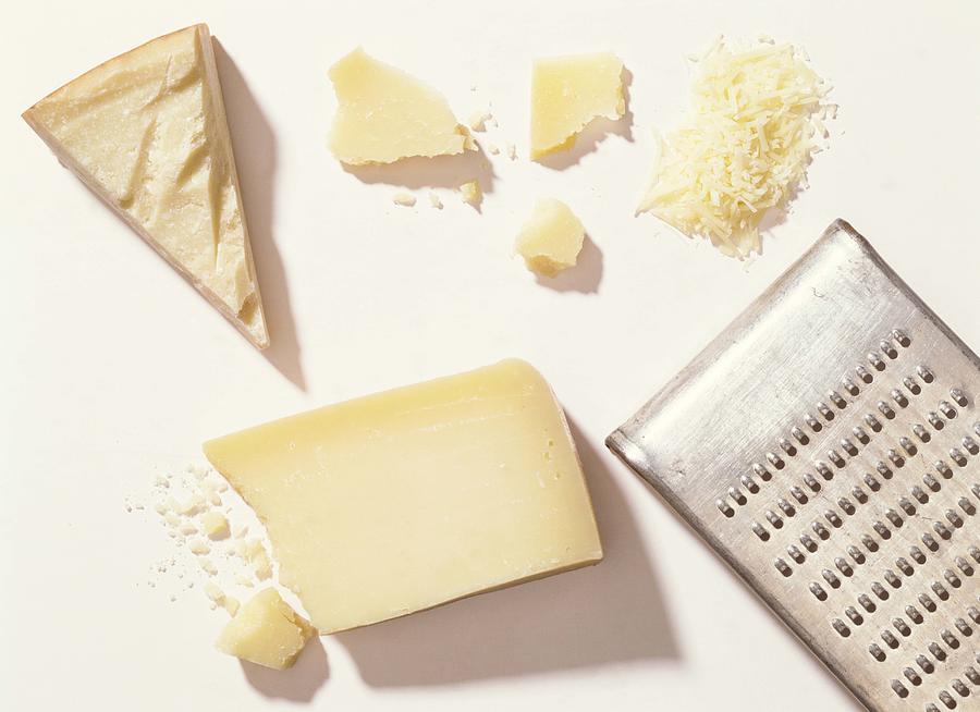 Parmesan cheese with grater Photograph by Jupiterimages