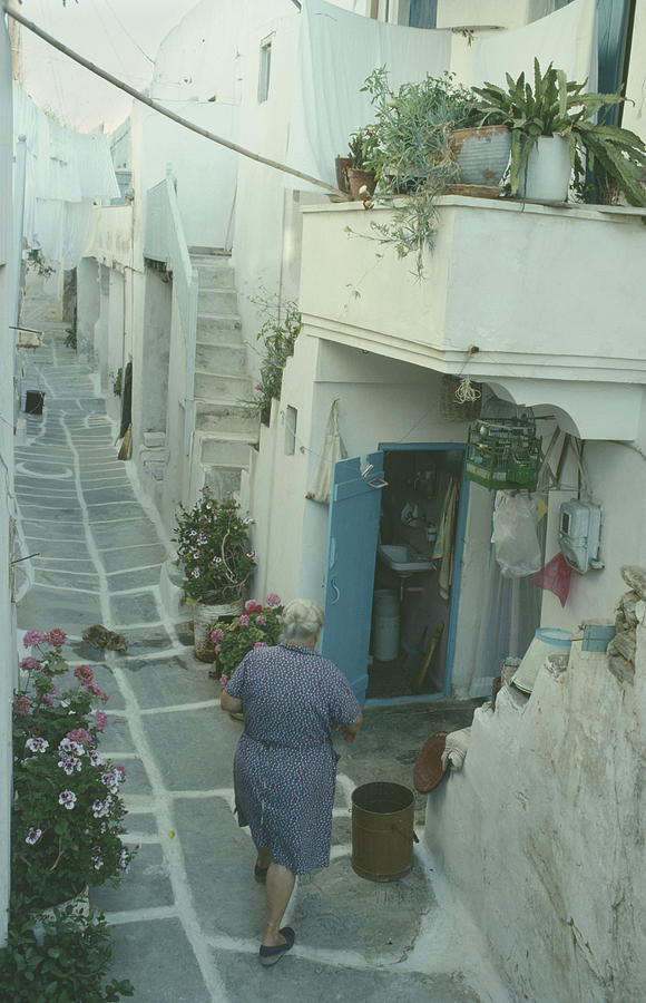 Paros Naousa street with lady walking to her house Photograph by George Shelley Productions