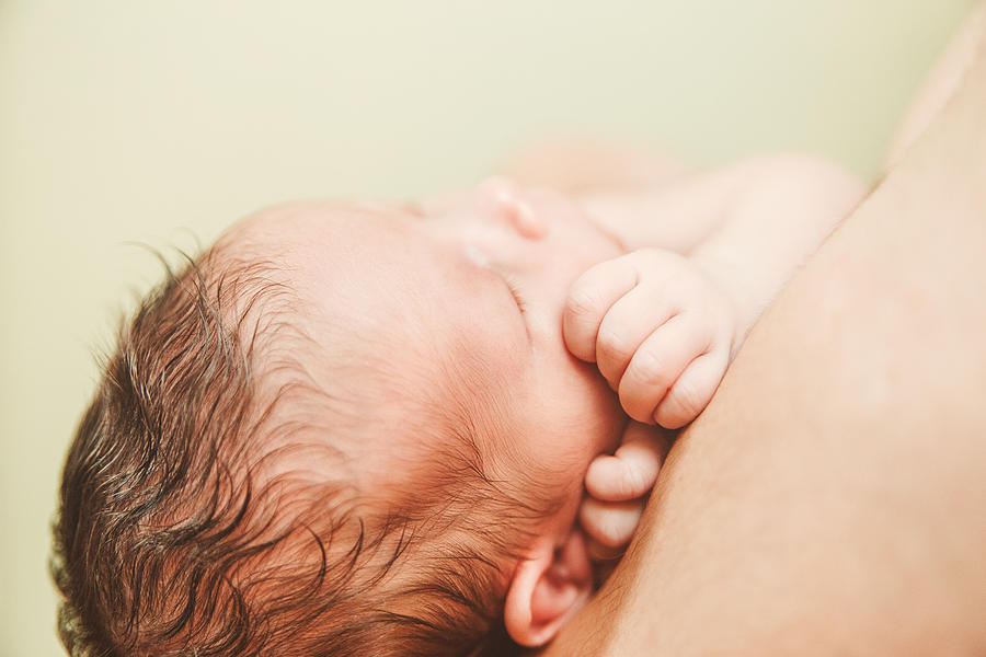 Part of Face Newborn Baby.Small Touching Hands. Photograph by KolomiyetsViktoriya