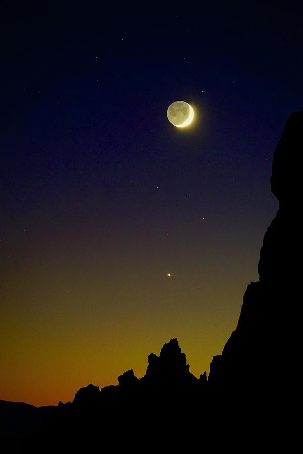 Partial moon and shining Jupiter Photograph by Brent Bunch