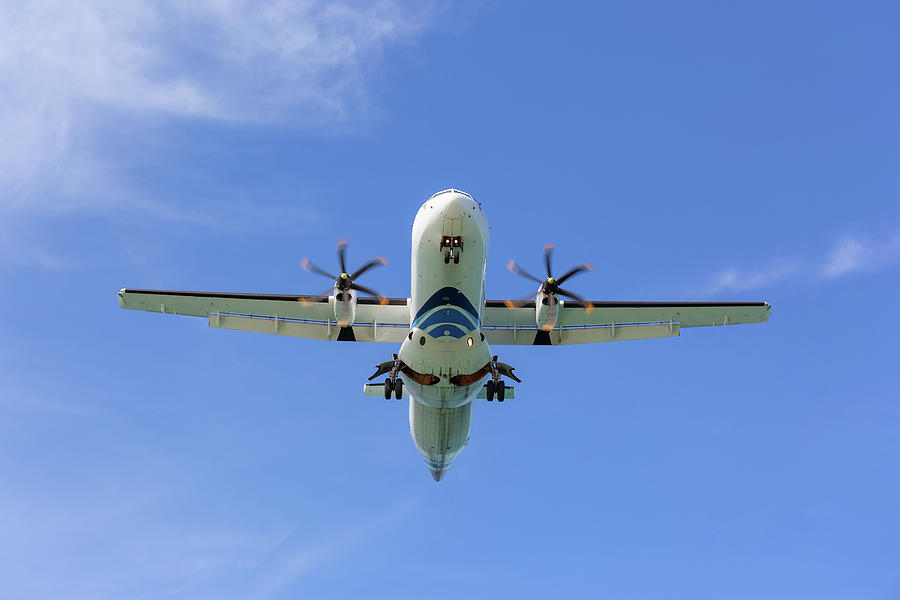 Passenger propeller airplane before landing Photograph by Mikhail Kokhanchikov