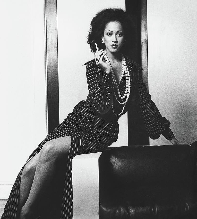  Pat Cleveland Holding A Cigarette Photograph by Bob Stone