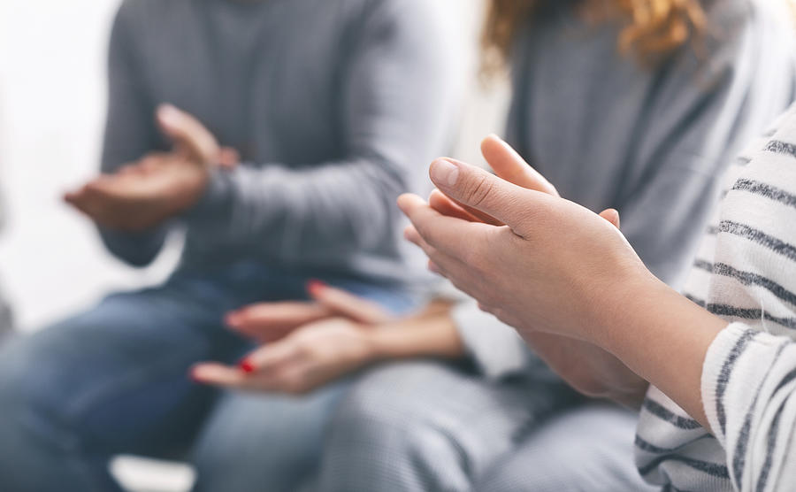 Patients clapping hands at psychotherapy session, close up Photograph by Prostock-Studio