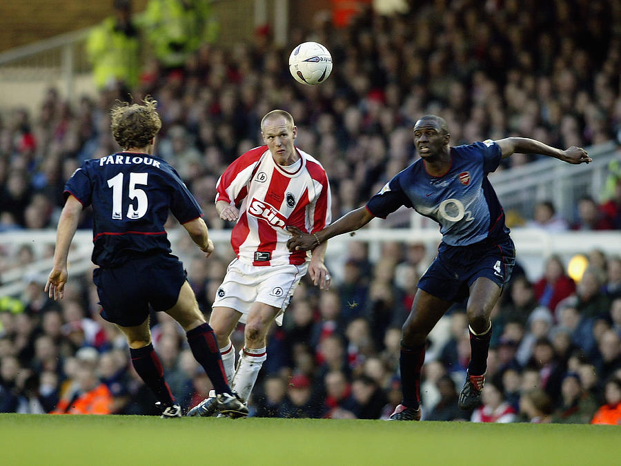 Patrick Vieira and Ray Parlour of Arsenal challenge Danny Carroll of Farnborough Town Photograph by Mark Thompson
