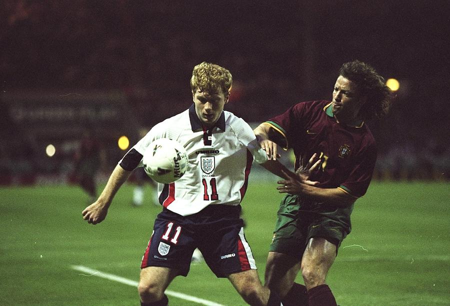 Paul Scholes of England holds off Jorge Cadete of Portugal Photograph by Laurence Griffiths