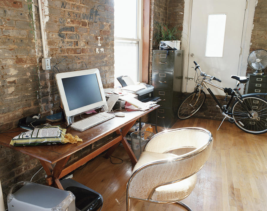 PC, Desk and Bicycle Inside an Apartment Photograph by Digital Vision.