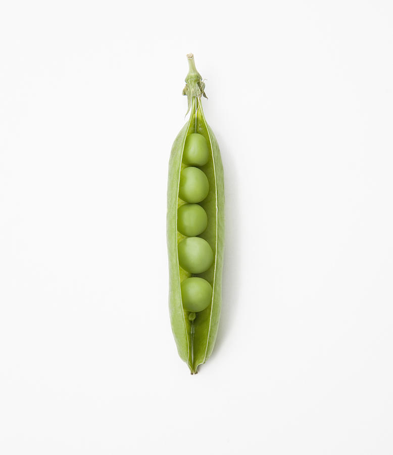 Pea pod containing peas - close up Photograph by Ashley Jouhar
