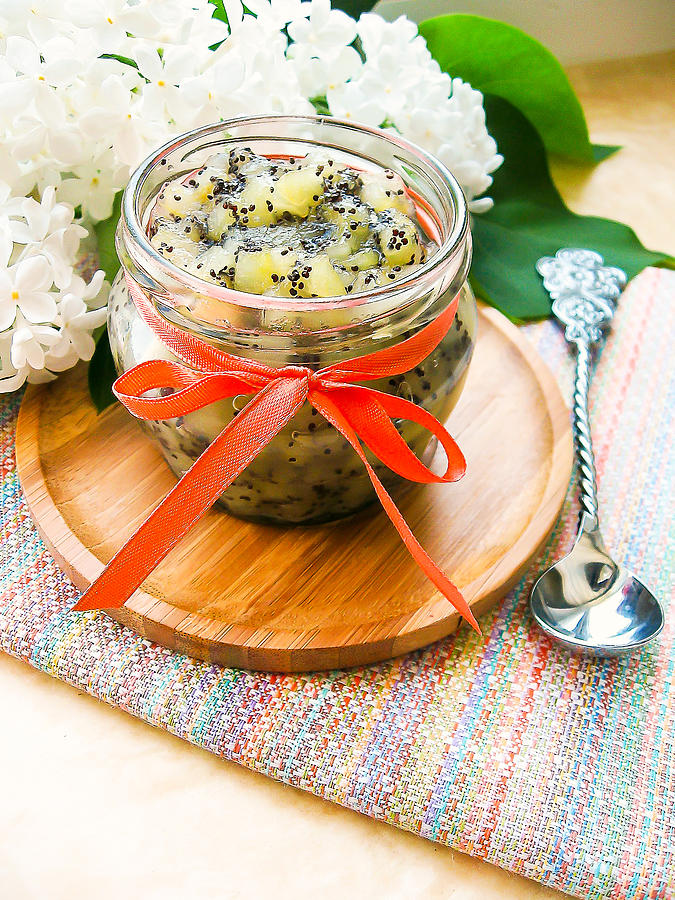 Pear jam or marmalade with poppy seeds in a jar, selective focus. Dessert food. Preserved food. Photograph by Anna Kurzaeva