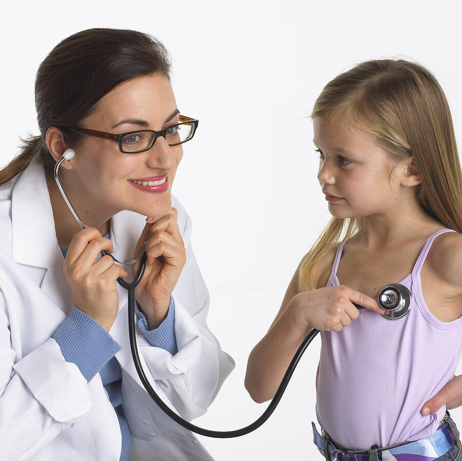 Pediatrician listening to girls heart Photograph by Brand X Pictures