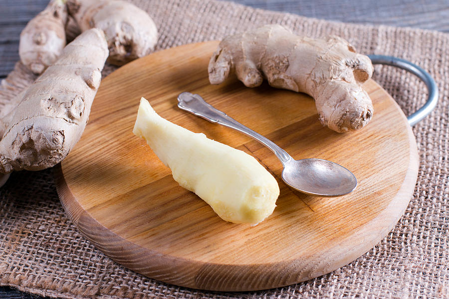 Peeled ginger root on a cutting board Photograph by Qwart