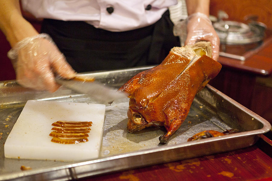 Peking roast duck being sliced Photograph by DigiPub