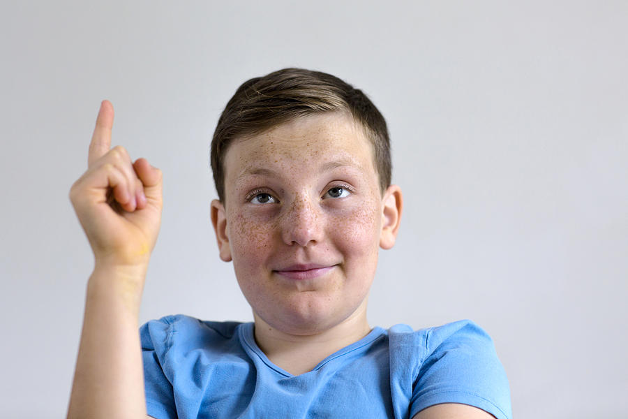Pensive boy with finger raised Photograph by Gombert, Sigrid/science Photo Library