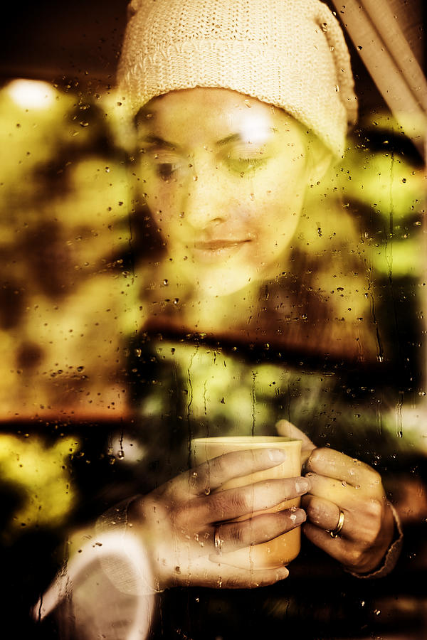 Pensive woman looking through a window Photograph by Mauro_grigollo