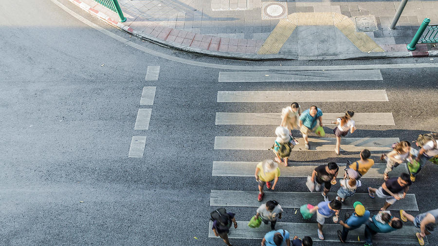 People are moving across crosswalk  in the city Photograph by Ultramansk