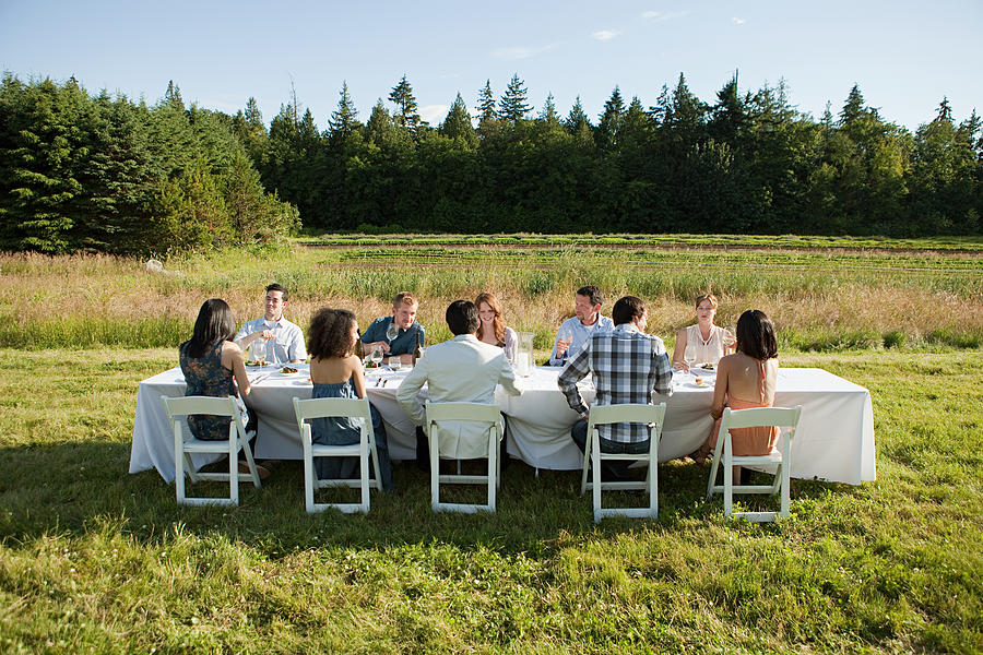 People at dinner party on a farm Photograph by Image Source