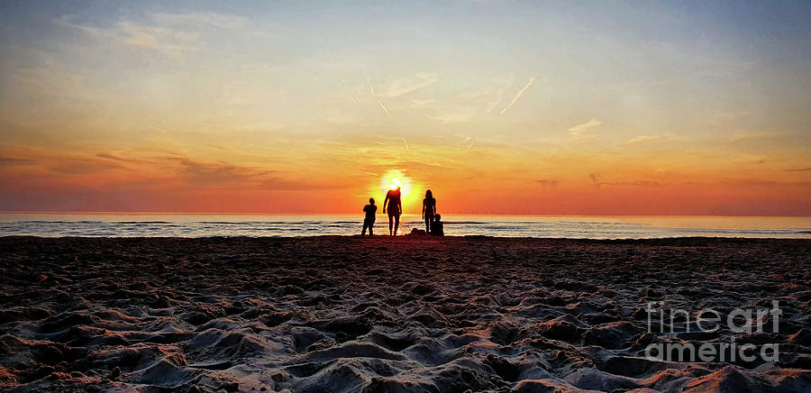 People at the beach during golden sunset on the North Sea in Netherlands Photograph by Mendelex Photography