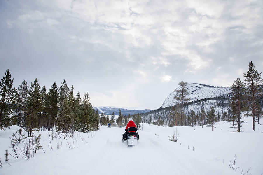 People Drive Snowmobiles on a Mountain in Rural Norway, Wintertime Photograph by Morten Falch Sortland