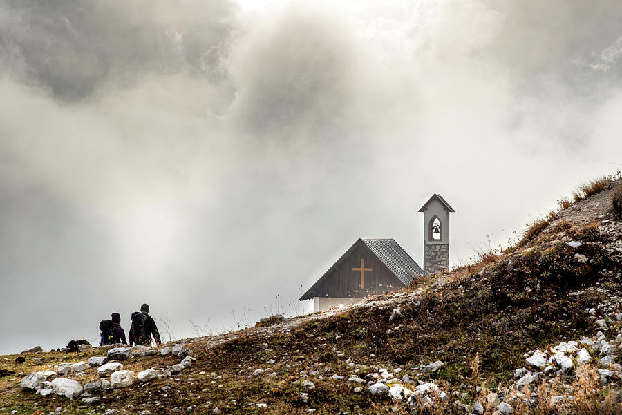 People hiking the trail to the church at Tre cime di lavadero. Italian Alps Italy Photograph by Michalakis Ppalis