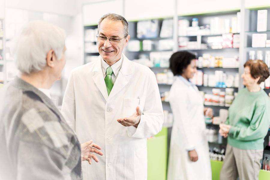 People in a pharmacy. Photograph by Skynesher
