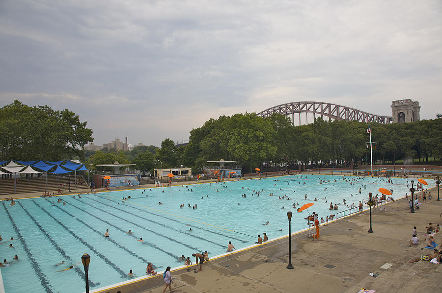 People in Astoria Pool in Astoria Park beneath Hell Gate Bridge, Astoria, Queens, NY Photograph by Barry Winiker