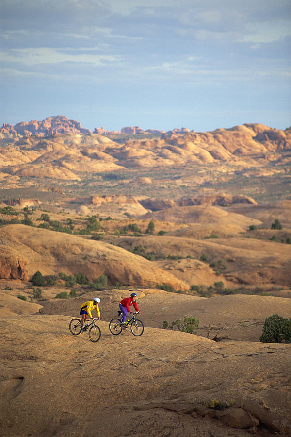 People mountain biking Photograph by Comstock Images