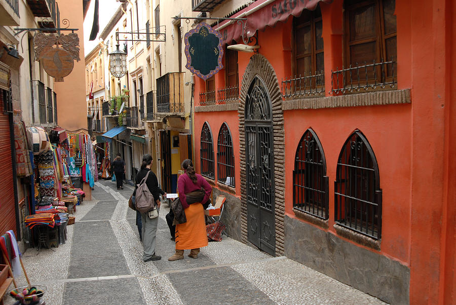 People on walkway between buildings in Albaycin, Granada Photograph by Grahamheywood