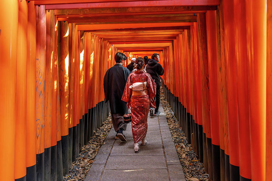 People pass under the torii of the Fushimi inari temple Photograph by Gualtiero Boffi