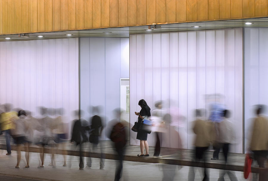 People passing modern illuminated building Photograph by EschCollection