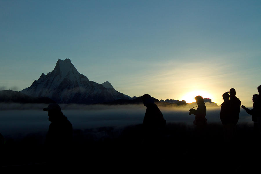 People silhouettes by high mountain at sunrise Photograph by David Oliete