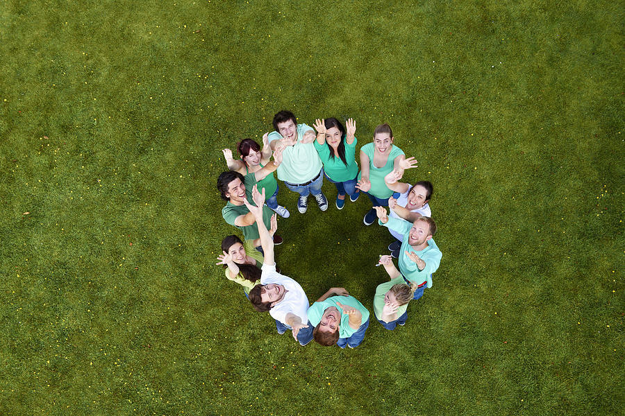 People standing in a circle on grass Photograph by Photo_Concepts