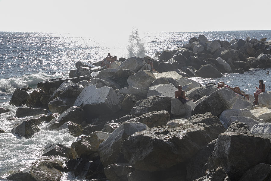 People sunbathing peacefully at Cinque Terre Five lands, on the rugged Ligurian coast of Italy. Photograph by ChristiLaLiberte