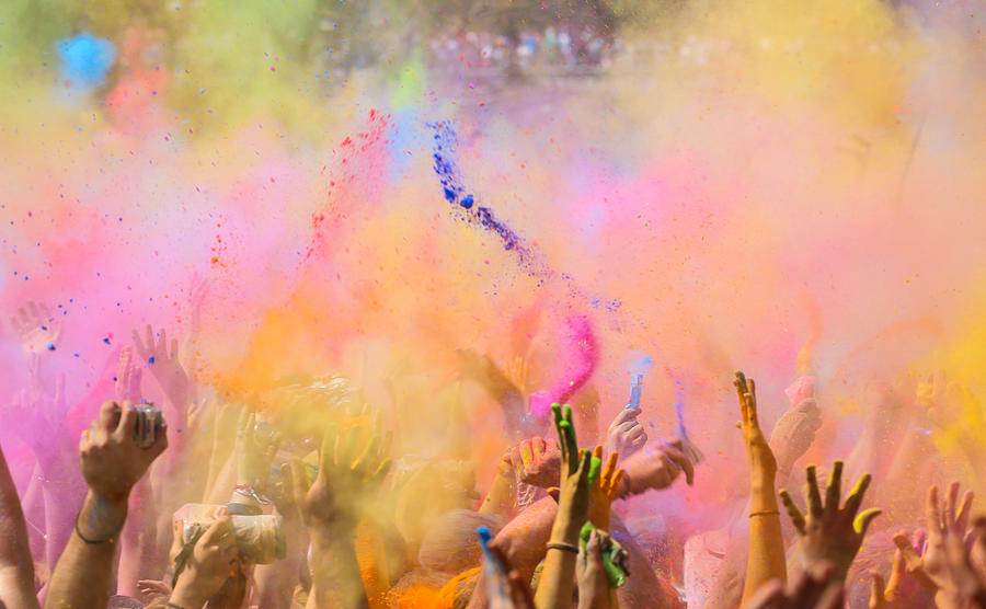 People throwing colorful powder in Holi Photograph by Artur Debat