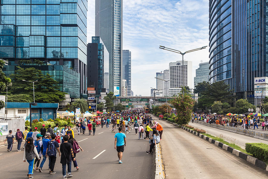 People walking on the streets of Jakarta business district Photograph by @ Didier Marti
