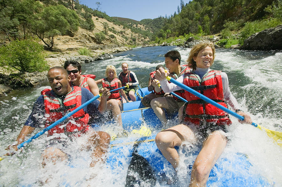 People whitewater rafting Photograph by Jupiterimages