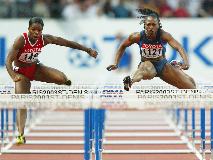 Perdita Felicien of Canada (L) in action next to Gail Devers of USA during the womens 100 meter hurdles semi-final  Photograph by Phil Cole