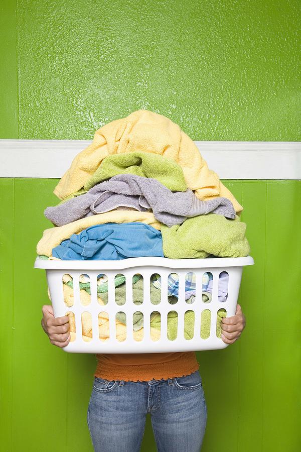 Person carrying laundry basket Photograph by Jupiterimages